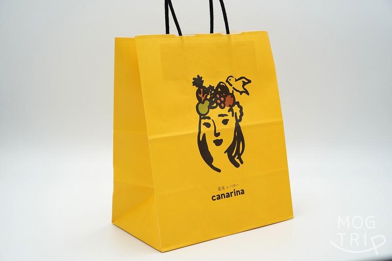 canarina（カナリナ）のショッパーがテーブルに置かれている